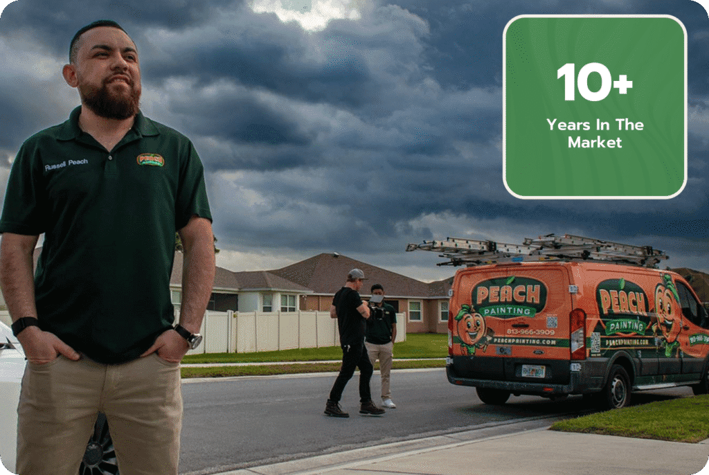 Russel Peach proud owner of the top painting company in tampa standing infront of his vechile